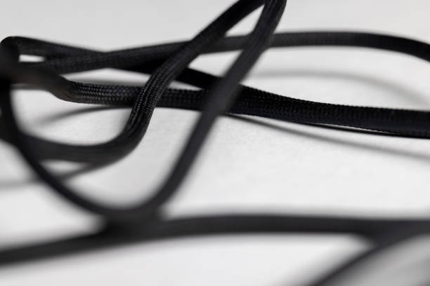 black braided wire for connecting electrical appliances, thin braided from black threads electric wire