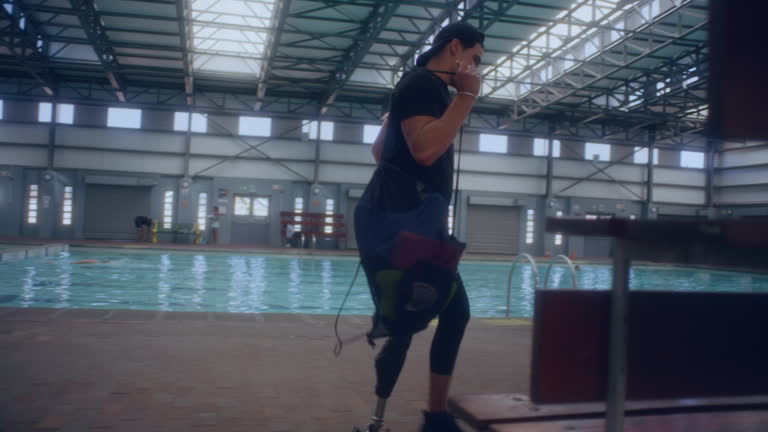 Paralympic swimmer with one leg near the pool