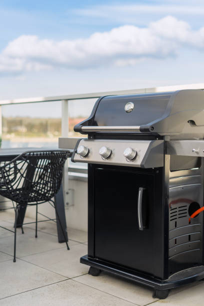 istock Black modern gas grill on rooftop patio, outdoor kitchen 2164864121