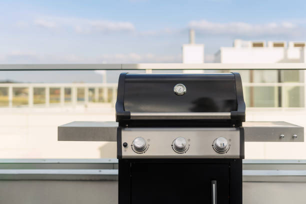 istock Black bbq gas grill sits on a rooftop patio 2164864128