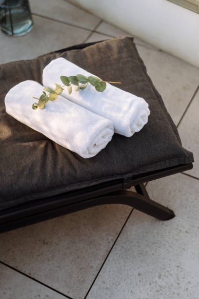 istock White towels neatly rolled and folded on lounge chair 2164864138