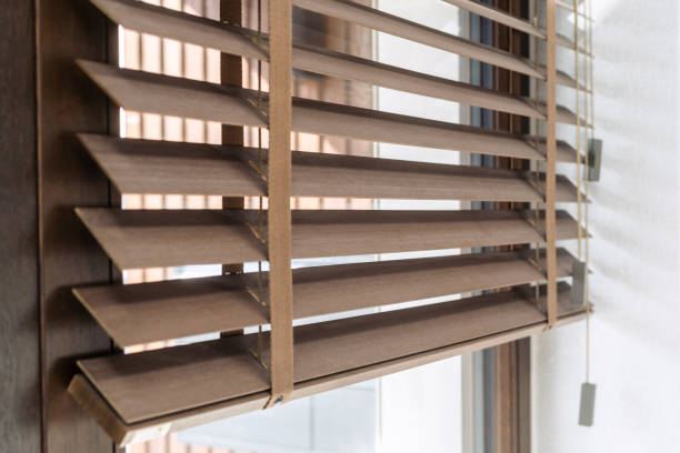 Brown and wooden window blinds, close up view