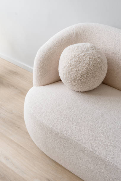 istock White plush sofa with round pillow on top, close up shot 2164864166