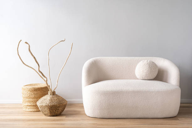 istock White sofa with dry wooden branches in wicker vases 2164864181