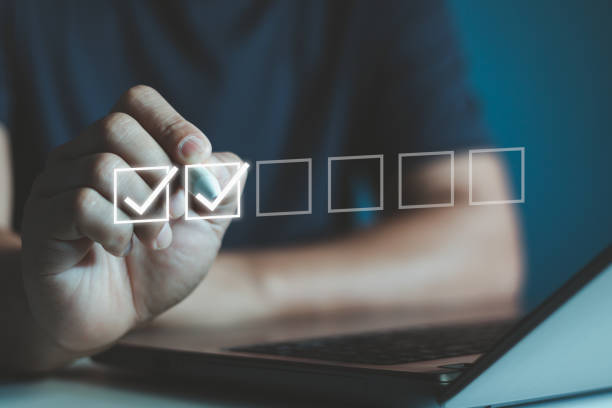 istock Checklist Concept with Businessman and Check Mark. Businessman is marking a check on a virtual checklist, representing task completion and organization in a professional business setting, filling out. 2164864226