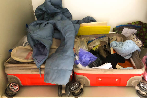 istock Messy Open Woman's Suitcase, Puffy Jacket, Shoes, Book 2164865835