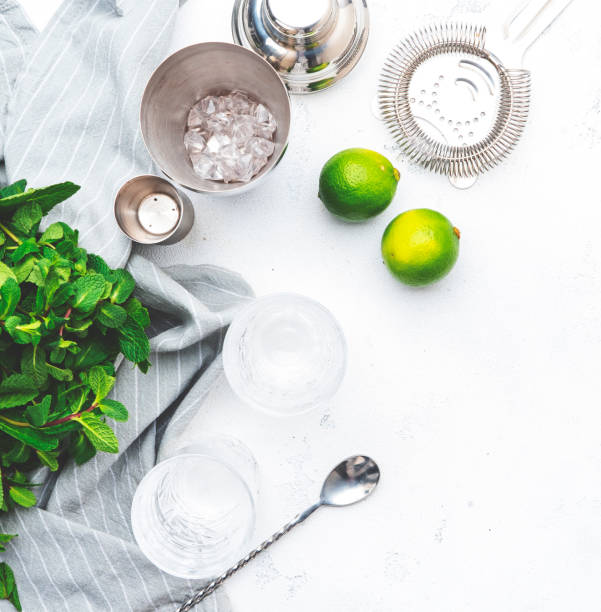 istock Ingredients for making alcoholic summer cocktail drink and bar tools, white background, top view 2164866285