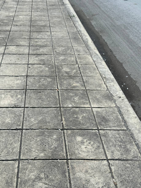 istock cement way near the road 2164869626