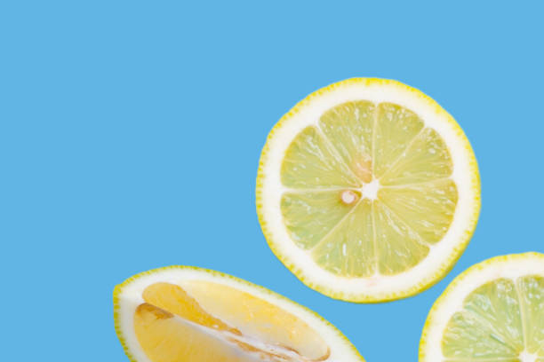 istock Fresh lemon slices isolated on blue 2164870036
