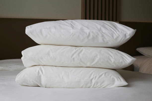 istock Bed with pillows in bedroom hotel 2164870876