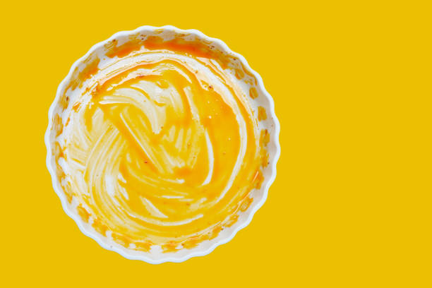 istock Dirty plate on yellow background. Top view 2164872560