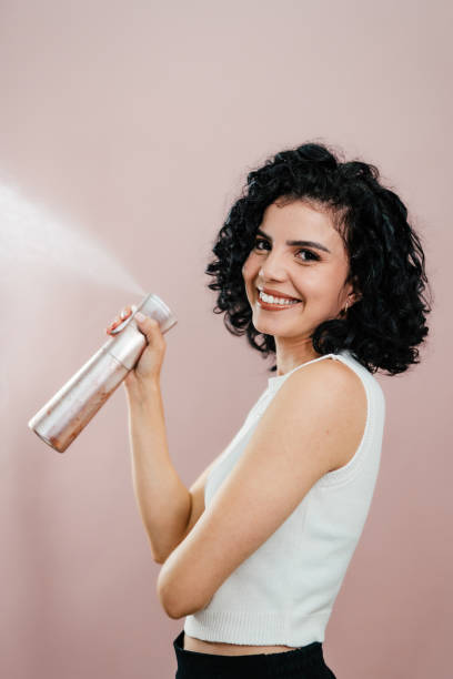 istock Woman squeezing a hairspray 2164874181