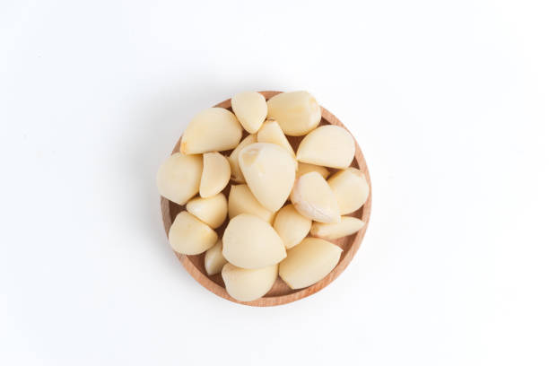 istock garlic in wooden container isolated white background. 2164875883