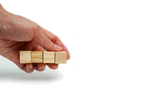 istock Man's hand placing wooden cube on white background, business concept. 2164882153