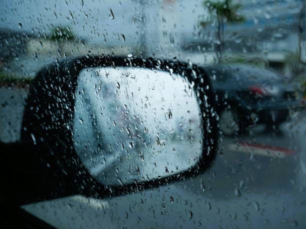 istock View of the side mirror of a car while it is raining. 2164885516