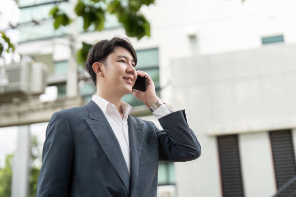 istock Confident Business Professional Talking on Smartphone Outdoors in Modern Urban Setting 2164886331
