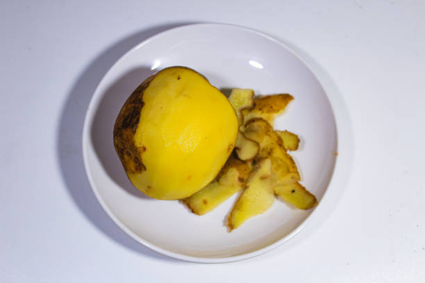 raw skinned potatoes on a white plate