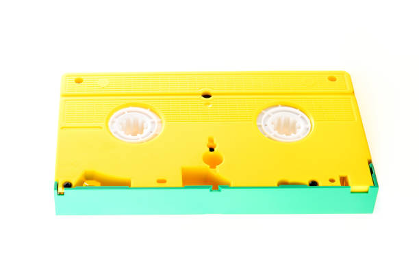 colored yellow and green video cassette isolated on white, retro analog tape VHS cassette, close up, side view
