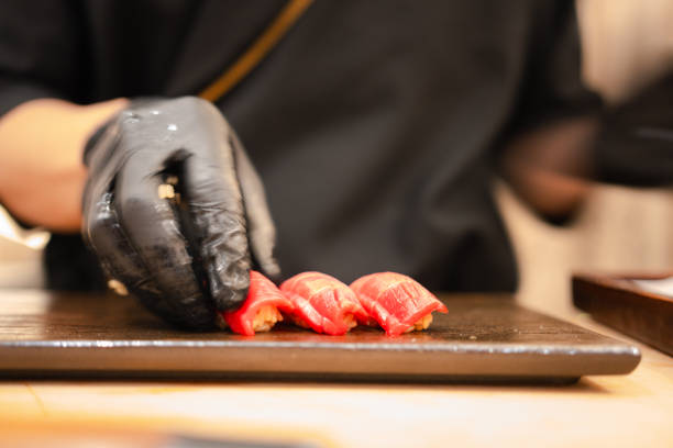 istock Japanese Omakase Style, close up chef making tuna sushi. 2164890793