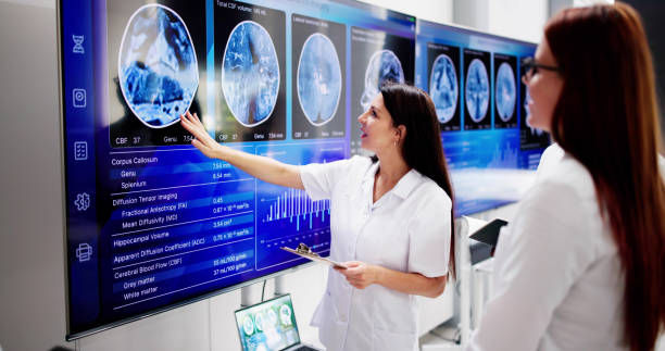 istock Doctors In Clinic Looking At Brain MRI Scan 2164892101