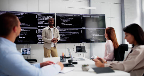 istock Programmer Team Meeting With TV Screen In Office 2164892104