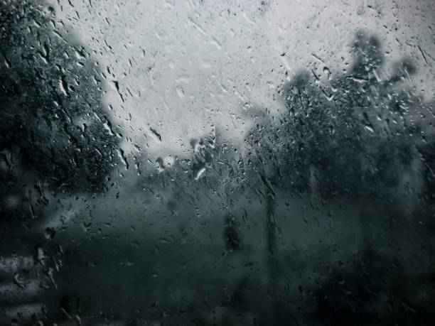 This image showcases dew drops on the window, creating a beautiful, misty view of the rainy season outside. heavy rain in Kuantan, Malaysia