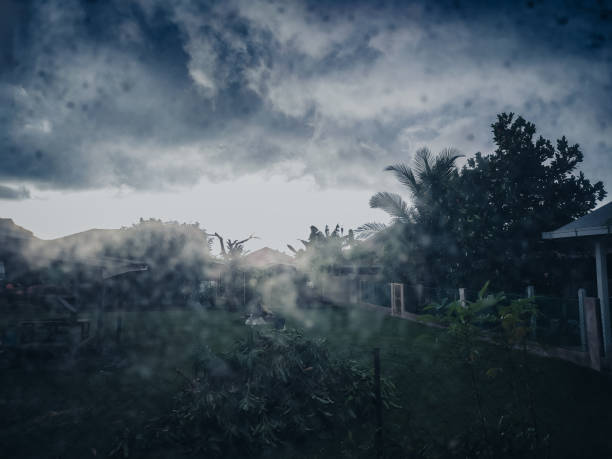 This image showcases dew drops on the window, creating a beautiful, misty view of the rainy season outside. heavy rain in Kuantan, Malaysia