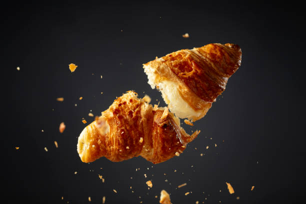 istock Croissant in air on a black background. 2164894867