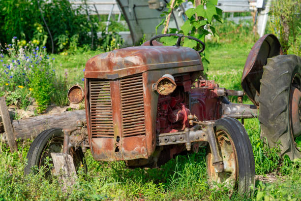 istock An old tractor is sitting in a field of grass 2164895231