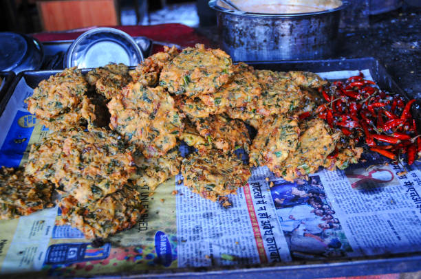 Veg pakoras in a tray at a tea stall. Pakoras are a popular deep-fried Indian appetizer.
