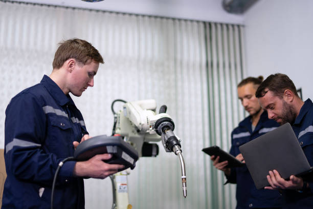 istock Group of Engineers are working at robotics workshop. 2164895822