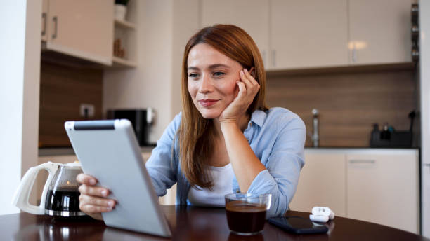 istock Beautiful woman watching something on a tablet 2164897583