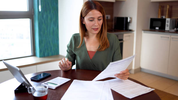 istock Young woman organizing her household budget 2164897689