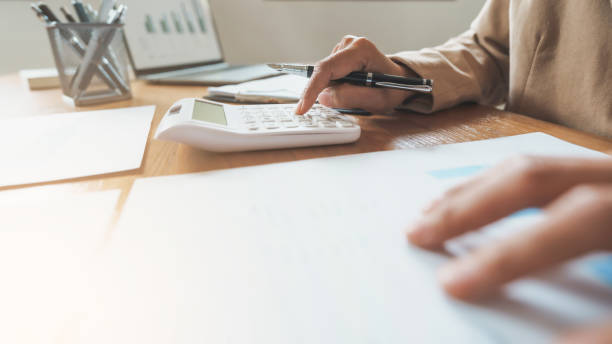 istock Business analyst calculating turnover figures in office. 2164904043