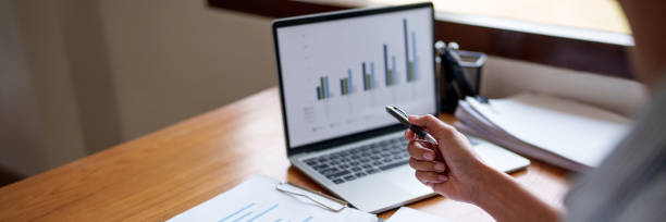 istock Hand holding pen pointing at laptop, online working corporate. 2164904065