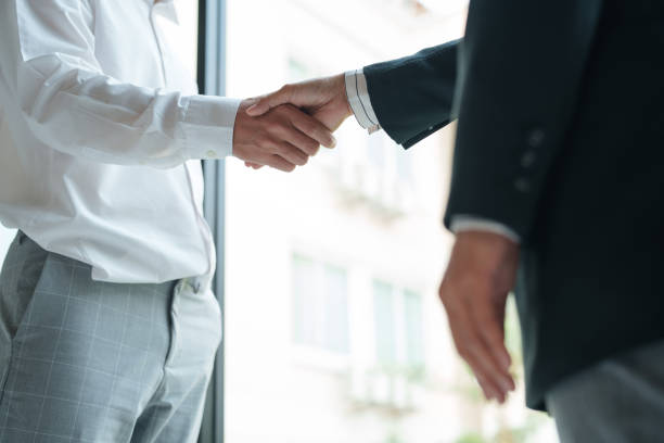 istock Executives business partnership handshake in meeting room. 2164904332