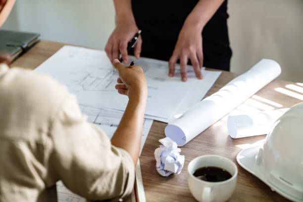 istock Architects interior designer hands working with Blue prints and documents for a home renovationÂ for house design 2164904489