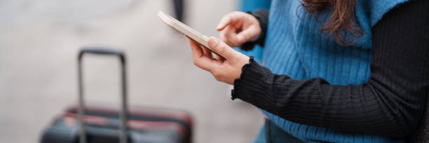 istock Tourist with luggage using smartphone checking trip for travel. 2164904655