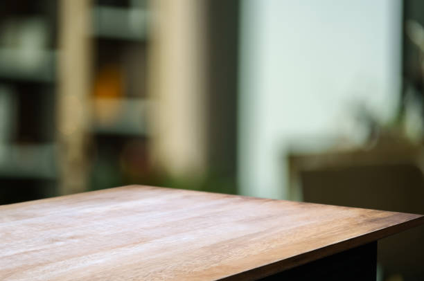 istock Wooden table with blurred goods shelf background. 2164904702