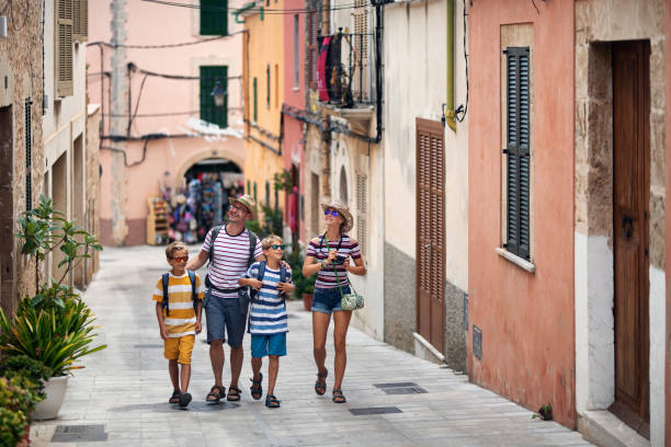 istock Family walking joyfully through a charming Spanish street 2164905305