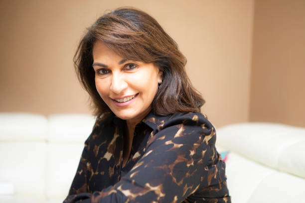 istock Cheerful mature woman sitting on a sofa 2164908108