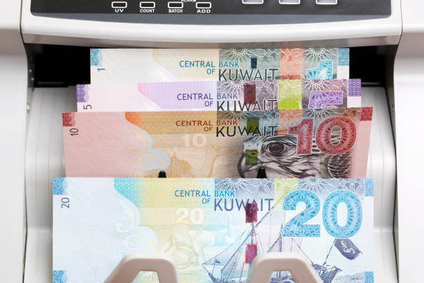 istock Kuwaiti  dinar in the counting machine 2164908129