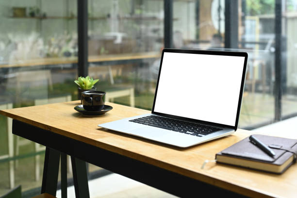 istock A laptop computer with blank screen, coffee cup and notebook on wooden table in coffee shop 2164910365