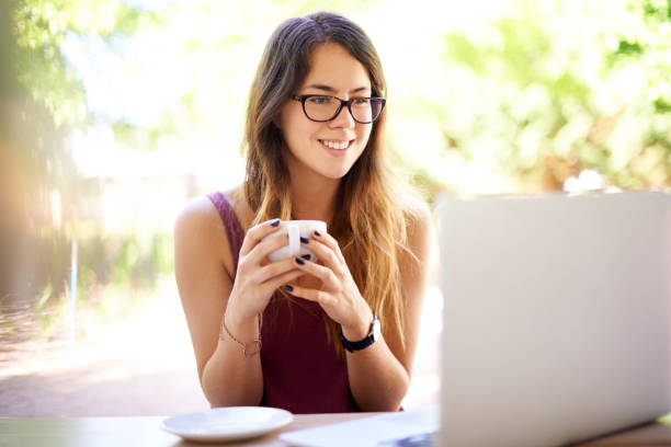 istock Coffee, happy and woman with laptop outdoors for reading email, networking and remote work. Cafe, restaurant and person on computer for internet, project and website research with caffeine drink 2164910487