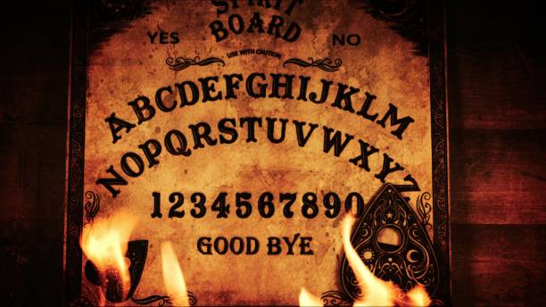 istock Witchcraft Spiritual Game Ouija Board and Fire 2164913476