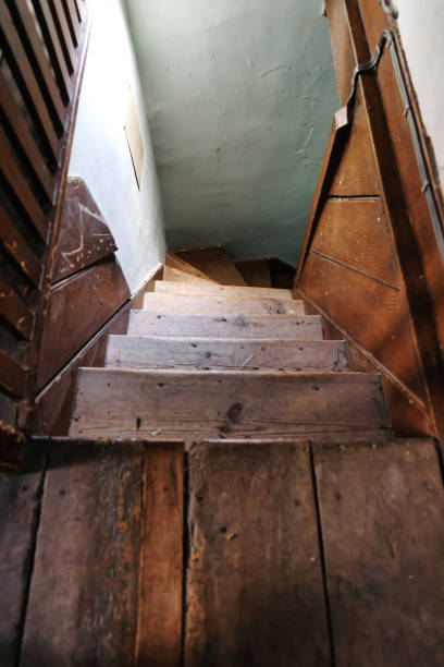 istock looking down at a spooky old wooden staircase 2164915652