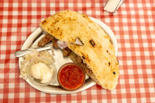istock Delicious Cevapi, a traditional Balkan dish, with sour cream and ajvar on the side 2164927405