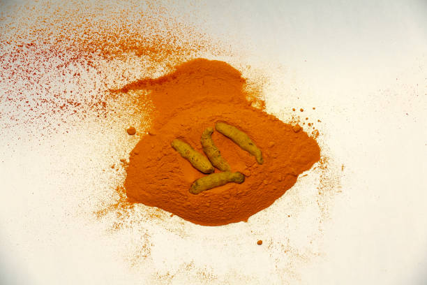 Turmeric roots and powder isolated on white background table top view