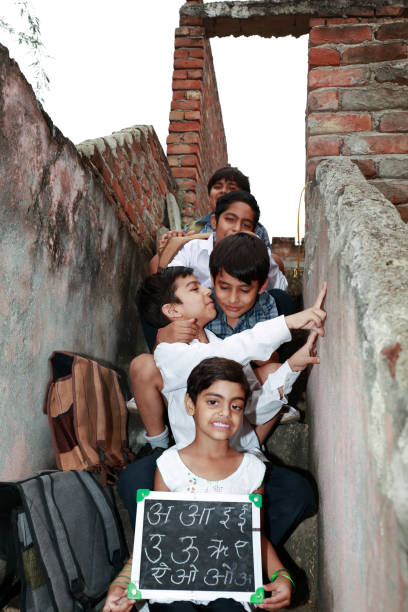 istock Elementary students sitting in a row at home in staircase 2164932117