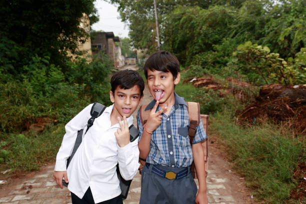 a cute indian asian boy of 5 years with gorgeous eyes and jovial facial expression in light background